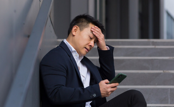 Man sitting looking at his phone